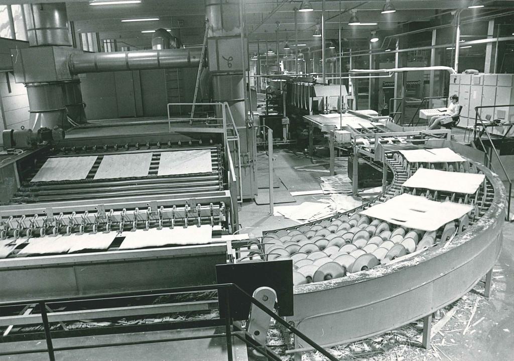 Black and white picture of a drying machine. Veneers are on the line.